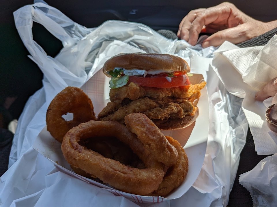 Crispy chicken pieces beside coleslaw and fries.